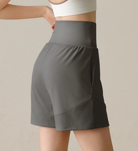 Detail showing high-waisted dark grey sports shorts with side pockets and slim fit seams