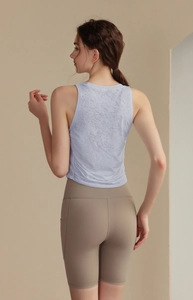 Detail of light blue jacquard yoga tank top with textured fabric and slim fit design
