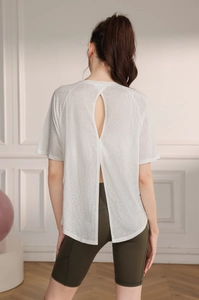 Back view of a white breathable yoga top with split back design and sheer mesh fabric