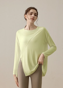 Detail view of yoga top featuring a side slit design and breathable sports fabric texture