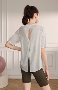 Detail of breathable semi-transparent fabric and split back design on a yoga top