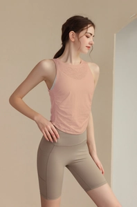 Detail view of peach slim-fit jacquard yoga tank top with side pleats and pockets