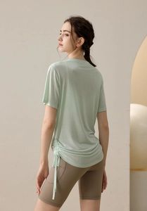 Detail of light green drawstring yoga top and athletic shorts with side pockets