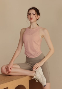 Detail of light pink mesh breathable yoga vest and khaki high-waisted biker shorts