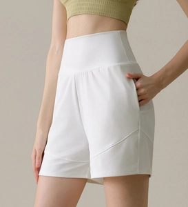 Detail view of white high-waist yoga shorts with side pocket and sleek stitching