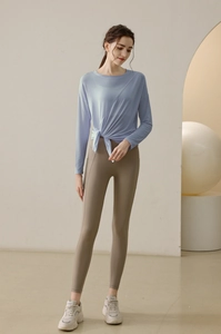 Close-up of women's light blue modal yoga top featuring a stylish front knot detail
