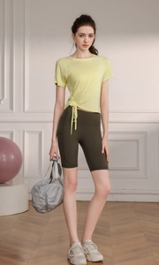 Women's light yellow drawstring yoga t-shirt and olive green biker shorts gym set