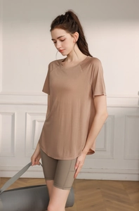 Close-up of lightweight brown yoga t-shirt with side split design and high-stretch fabric