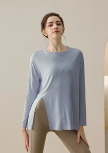 Detail view of light purple yoga top featuring a side slit and asymmetrical stitching