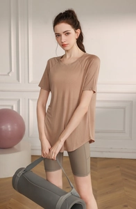 Close-up of lightweight yoga set with brown short-sleeved tee and high-waist cycling shorts