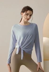 Detail of light blue modal sports top with side knot and high waist yoga leggings
