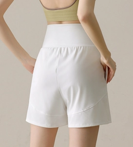 Close-up of white high-waisted nylon sports shorts with pocket and back lifting seams