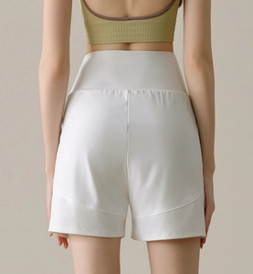 Detail of high waisted white sports shorts showing the curved rear seam for bum lifting effect