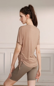 Detail of tencel yoga top featuring adjustable side drawstring and ruched texture