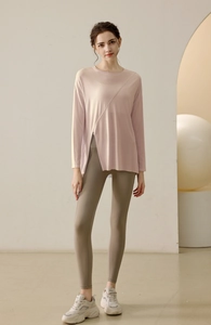 Detail view of mauve long sleeve modal sports top with side split and yoga leggings