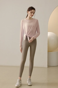 Detail view of pink loose yoga top with side tie knot and breathable quick dry fabric
