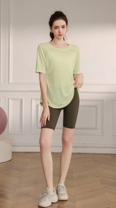 Close-up of lightweight light green yoga top with breathable mesh and side slit detail