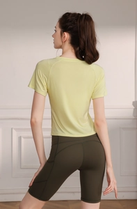 Detail view of high-waist olive green cycling shorts with functional side pockets