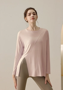 Detail view of pink long sleeve yoga shirt with side slit and soft breathable fabric