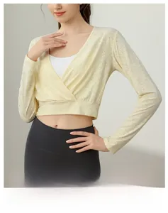 Detail of breathable jacquard mesh fabric on women's pale yellow long sleeve yoga top