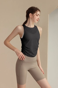 Detail view of black slim-fit yoga tank top with jacquard mesh texture and side rushing