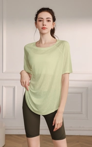 Detail view of mint green lightweight breathable yoga t-shirt with side slit design
