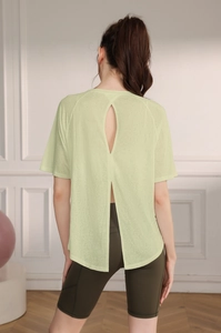 Detail of light green yoga top with back split and teardrop cutout for breathability