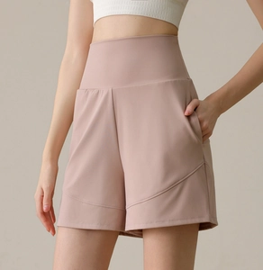 Close-up detail of high-waist yoga shorts showing side pockets and dusty rose fabric