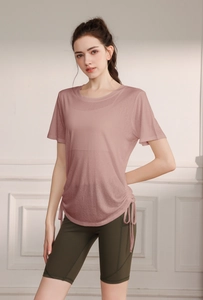 Detail of pink yoga t-shirt with adjustable drawstring and olive green cycling shorts