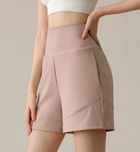 Detail of high-waist mauve athletic shorts with moisture-wicking fabric for yoga