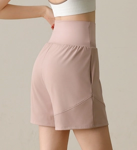 Detailed view of pink high-waisted gym shorts featuring side pockets and athletic seams