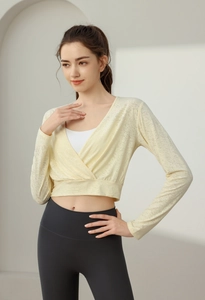 Detail view of light yellow V-neck yoga cover-up with subtle textured quick-dry fabric