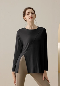 Detail of loose black yoga top with asymmetric side slit for breathability and style