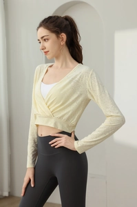 Detail of loose nylon yoga wrap top with V-neck and high waist fitness leggings