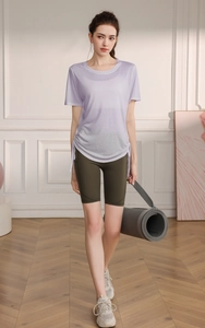 Detail of lavender drawstring yoga t-shirt and green biker shorts with side pockets