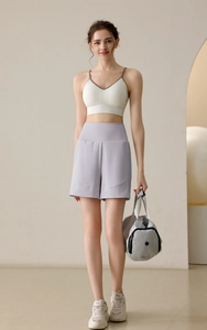 Close-up of lightweight nylon activewear set featuring a white camisole and lavender shorts