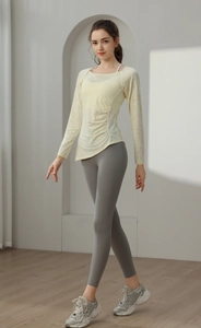 Detail of light yellow jacquard mesh yoga top with waist drawstring and breathable texture
