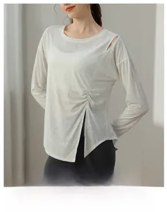Detail view of jacquard yoga top showing shoulder cutout and pleated texture in white
