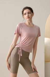 Detail of light pink drawstring yoga top with side cinching and high elasticity fabric