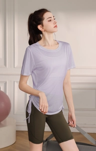 Detail view of the breathable fabric and adjustable side drawstring on yoga t-shirt