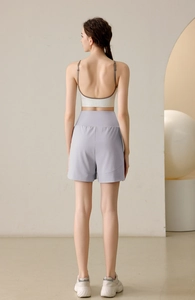 Rear view of women's lilac high-waisted athletic shorts and contrast sports bra set