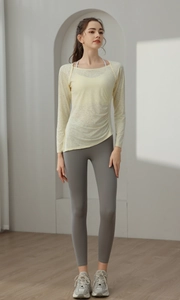 Detail of light yellow jacquard yoga top with drawstring ruched side and breathable mesh