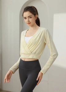 Detail view of breathable nylon jacquard long sleeve yoga top with cross cropped design