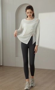 Macro detail of white breathable jacquard yoga top with side slit and drawstring waist