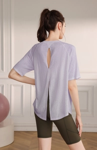 Detail of lavender yoga top featuring a stylish back slit and breathable mesh fabric
