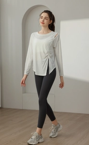 Detail of white split hem yoga top showing lightweight jacquard breathable fabric texture