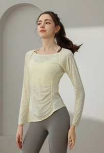 Detail of yellow nylon jacquard yoga top with side drawstring ruching and breathable texture