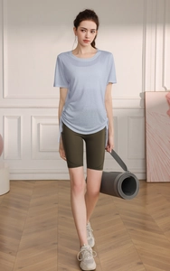 Detail view of light blue fitness T-shirt with side drawstring and olive green yoga shorts