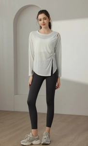 Detail of white yoga cover-up with shoulder cutout and side drawstring slit design