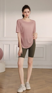 Close-up of lightweight lotus pink yoga shirt and high-waist green cycling shorts